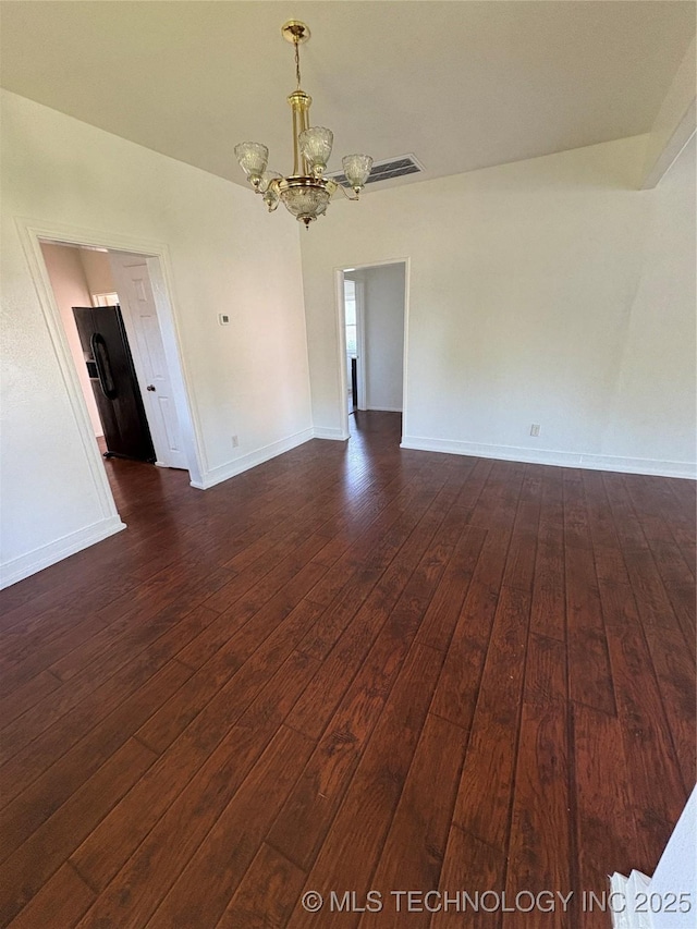 108 N Creek Ave, Bartlesville, OK 74003 - empty room with a chandelier, dark wood-style flooring, and baseboards