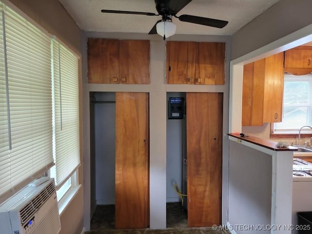 108 N Creek Ave, Bartlesville, OK 74003 - kitchen with brown cabinets, a sink, a ceiling fan, and cooling unit
