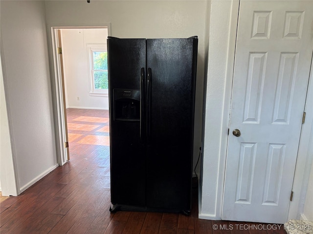 108 N Creek Ave, Bartlesville, OK 74003 - kitchen featuring black fridge, dark wood-style flooring, and baseboards