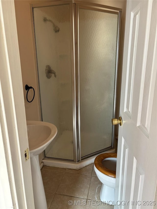 108 N Creek Ave, Bartlesville, OK 74003 - bathroom featuring tile patterned floors, a shower stall, and toilet