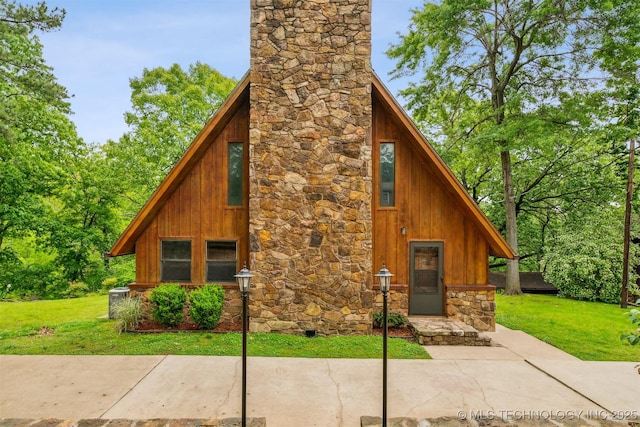 205 Woods Dr, Bernice, OK 74331 - view of front of house with a chimney, a front yard, and stone siding