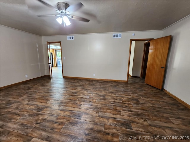 unfurnished room with dark wood-style flooring, a ceiling fan, baseboards, and crown molding