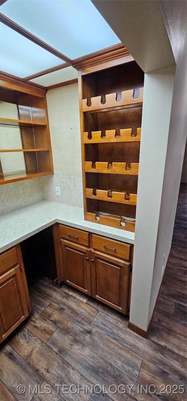 unfurnished office with built in study area and dark wood finished floors