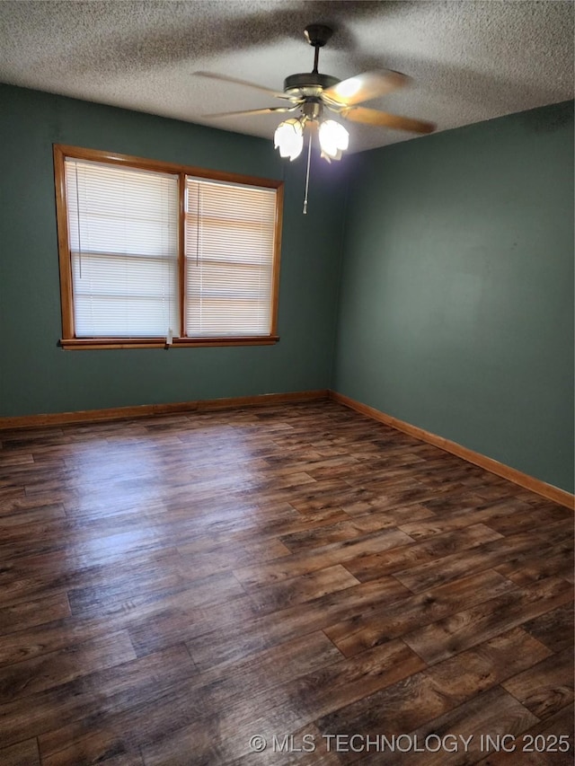 unfurnished room with ceiling fan, dark wood-style floors, baseboards, and a textured ceiling