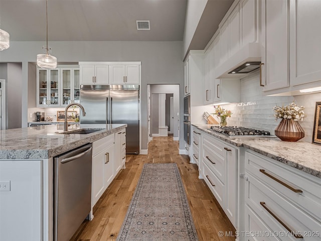 13606 S 21st Pl E, Bixby, OK 74008 - kitchen with a sink, built in appliances, white cabinets, and an island with sink