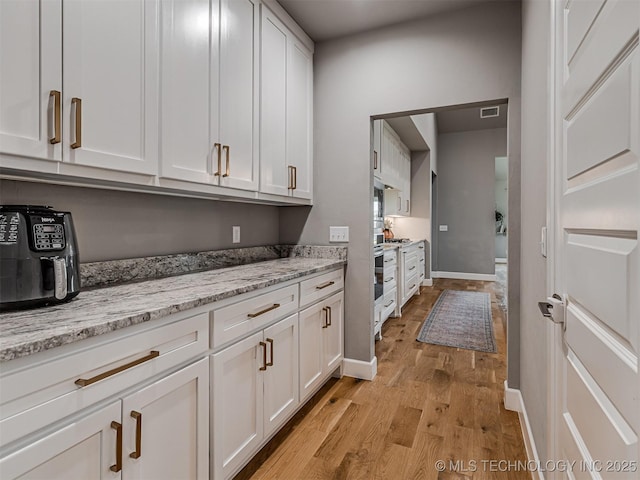 13606 S 21st Pl E, Bixby, OK 74008 - laundry room featuring light wood finished floors and baseboards