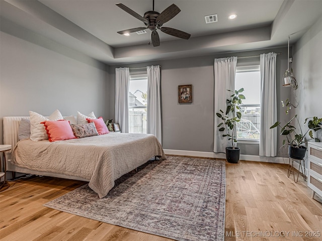 13606 S 21st Pl E, Bixby, OK 74008 - bedroom featuring a raised ceiling, multiple windows, and wood finished floors