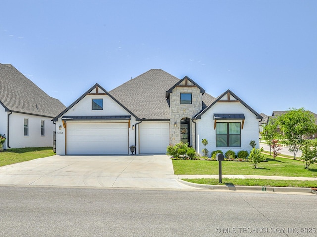 13606 S 21st Pl E, Bixby, OK 74008 - view of front of home featuring a garage, a front yard, driveway, stone siding, and a shingled roof