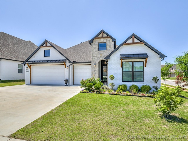 13606 S 21st Pl E, Bixby, OK 74008 - view of front of house with an attached garage, a front lawn, concrete driveway, a standing seam roof, and stone siding