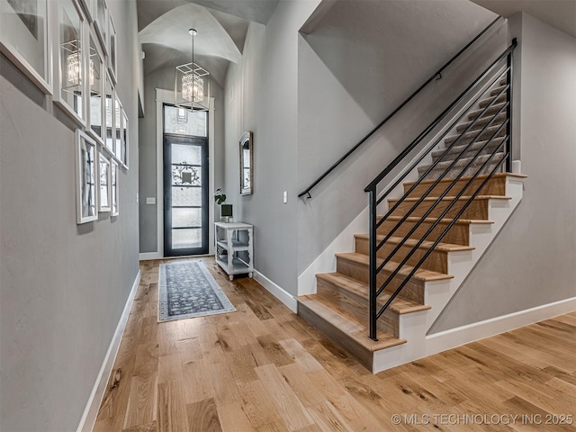 13606 S 21st Pl E, Bixby, OK 74008 - foyer entrance featuring baseboards, a chandelier, wood finished floors, stairway, and a high ceiling
