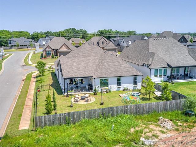 13606 S 21st Pl E, Bixby, OK 74008 - rear view of house with roof with shingles, a residential view, an outdoor fire pit, and a patio area