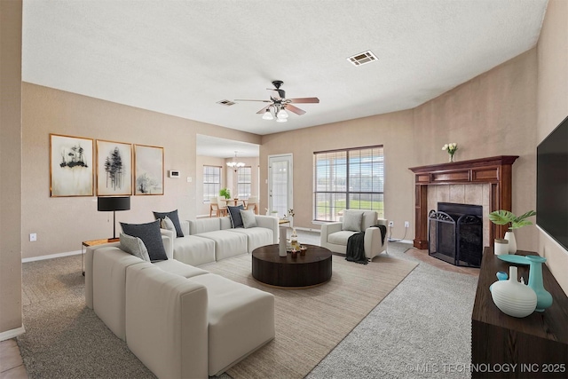 205 Summit, Durant, OK 74701 - living area with ceiling fan, a fireplace, baseboards, carpet flooring, and a textured ceiling