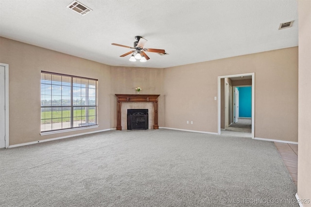 205 Summit, Durant, OK 74701 - unfurnished living room with ceiling fan, a tiled fireplace, carpet flooring, and baseboards
