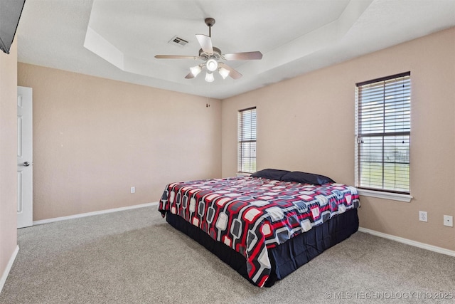 205 Summit, Durant, OK 74701 - carpeted bedroom featuring a raised ceiling, baseboards, and ceiling fan