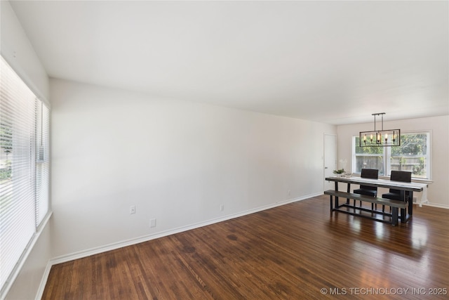 5433 S Boston Ave, Tulsa, OK 74105 - dining room featuring dark wood-style flooring, a chandelier, and baseboards