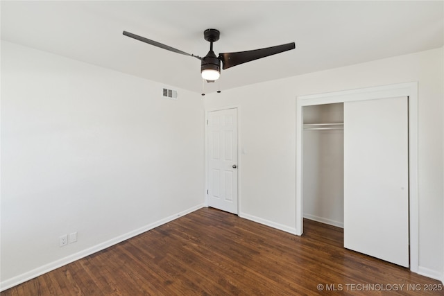 5433 S Boston Ave, Tulsa, OK 74105 - unfurnished bedroom with dark wood-type flooring, baseboards, and a closet