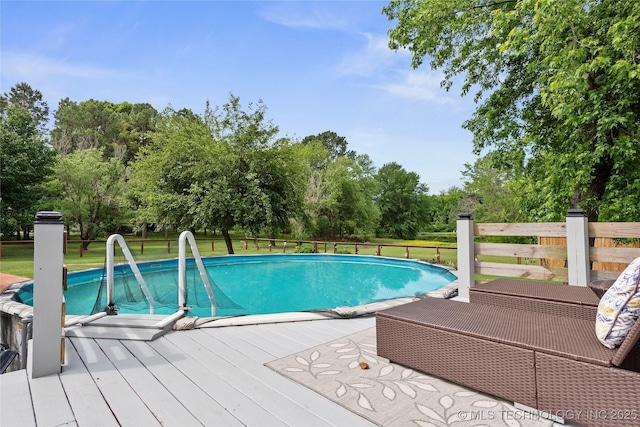 2961 N 24th St W, Muskogee, OK 74401 - swimming pool with a deck, view of wooded area, and a yard
