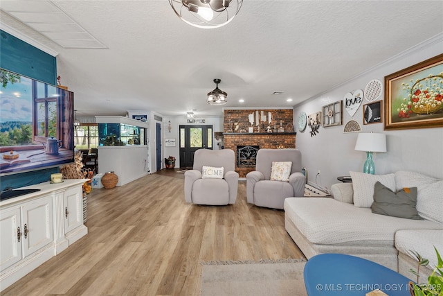 2961 N 24th St W, Muskogee, OK 74401 - living area featuring light wood-type flooring, a textured ceiling, a brick fireplace, and recessed lighting