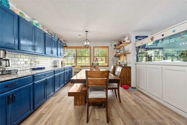 2961 N 24th St W, Muskogee, OK 74401 - dining space featuring light wood finished floors, a textured ceiling, crown molding, and a chandelier