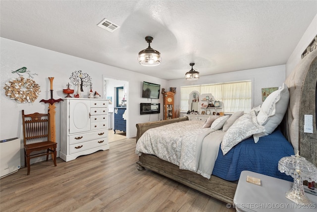 2961 N 24th St W, Muskogee, OK 74401 - bedroom featuring wood finished floors and a textured ceiling