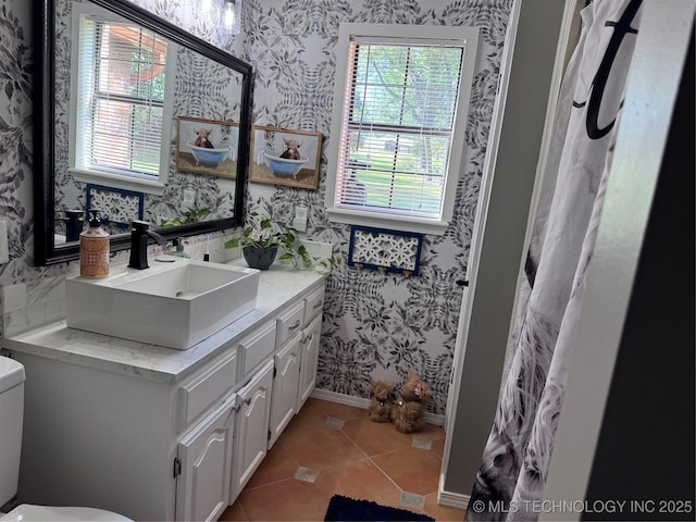 2961 N 24th St W, Muskogee, OK 74401 - bathroom with wallpapered walls, healthy amount of natural light, vanity, and tile patterned flooring