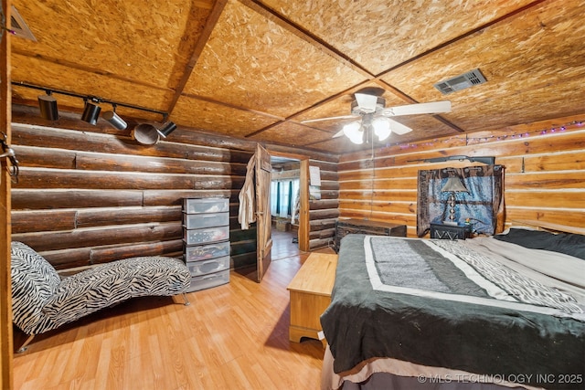 21170 S 270th Rd, Morris, OK 74445 - bedroom featuring log walls and wood finished floors