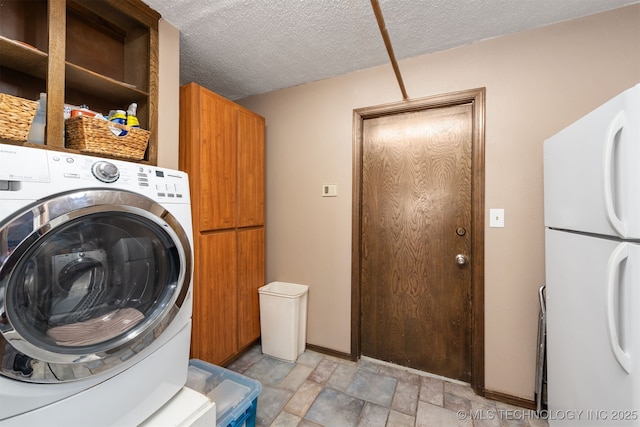 washroom with washer / clothes dryer, cabinet space, stone finish floors, and a textured ceiling