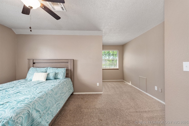 carpeted bedroom with a textured ceiling, baseboards, and a ceiling fan