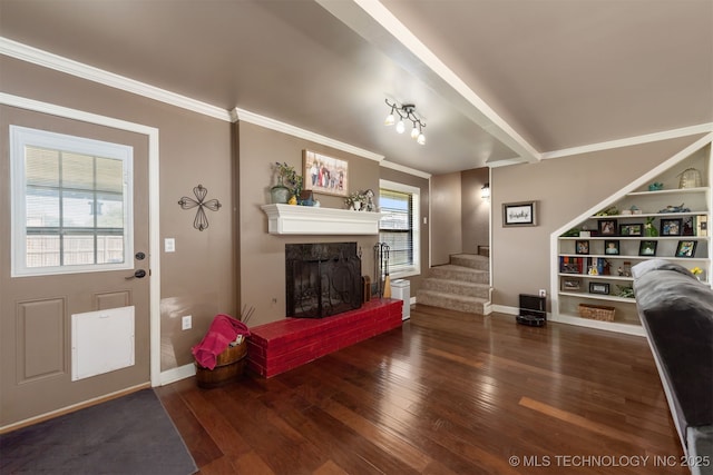living room with hardwood / wood-style floors, a premium fireplace, baseboards, ornamental molding, and stairway