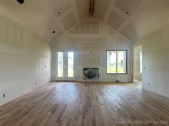 31005 E 67th St S, Broken Arrow, OK 74014 - unfurnished living room with high vaulted ceiling, wood finished floors, healthy amount of natural light, beam ceiling, and a fireplace