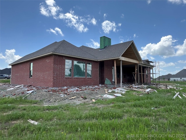 31005 E 67th St S, Broken Arrow, OK 74014 - view of side of home featuring brick siding, a chimney, and a shingled roof