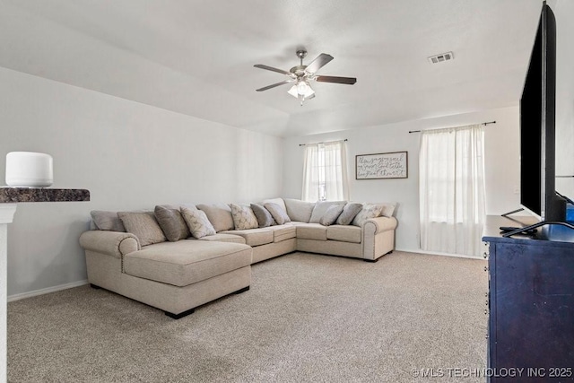 carpeted living area with ceiling fan