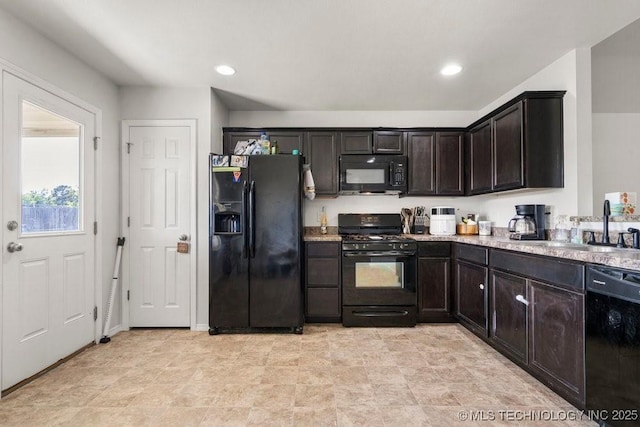 kitchen featuring black appliances, dark brown cabinets, a sink, and recessed lighting