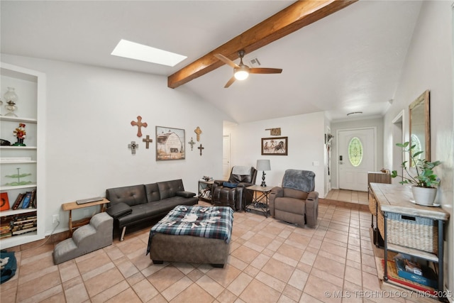 living area featuring a skylight, a ceiling fan, light tile patterned floors, and built in shelves