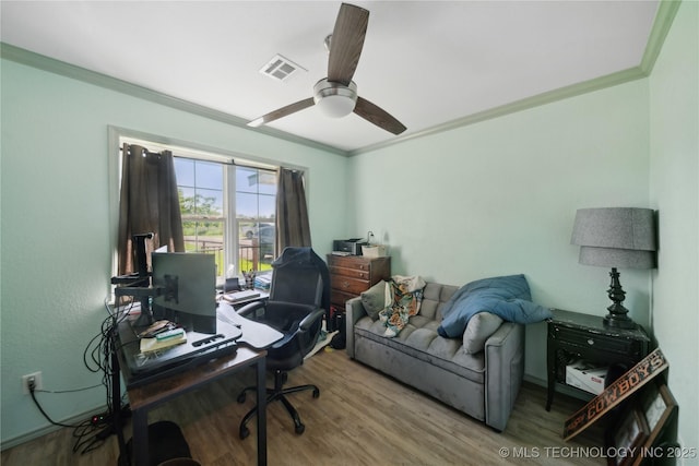 home office featuring crown molding, wood finished floors, and a ceiling fan