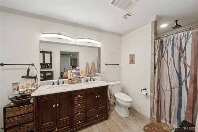 full bathroom featuring toilet, ornamental molding, double vanity, a shower with shower curtain, and wood finished floors