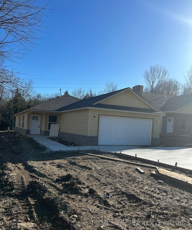 single story home with an attached garage, driveway, and brick siding