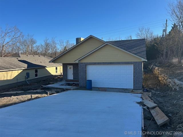 ranch-style house featuring driveway, brick siding, and an attached garage