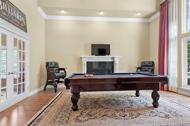 10105 S 72nd E Ave, Tulsa, OK 74133 - game room featuring ornamental molding, healthy amount of natural light, wood finished floors, french doors, and a tile fireplace