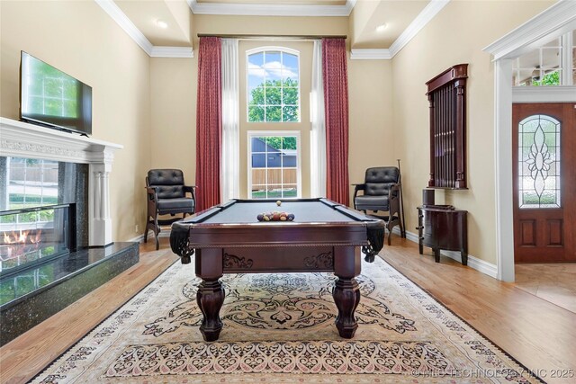 10105 S 72nd E Ave, Tulsa, OK 74133 - rec room with a high end fireplace, billiards, wood finished floors, ornamental molding, and baseboards