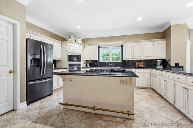 10105 S 72nd E Ave, Tulsa, OK 74133 - kitchen featuring stainless steel appliances, a center island, backsplash, ornamental molding, and a sink