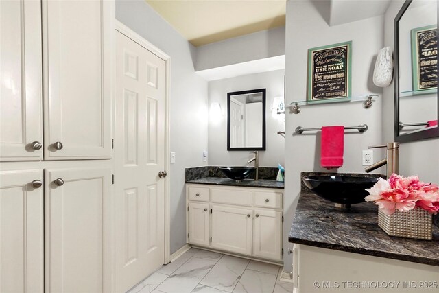 10105 S 72nd E Ave, Tulsa, OK 74133 - bathroom with marble finish floors, two vanities, and baseboards