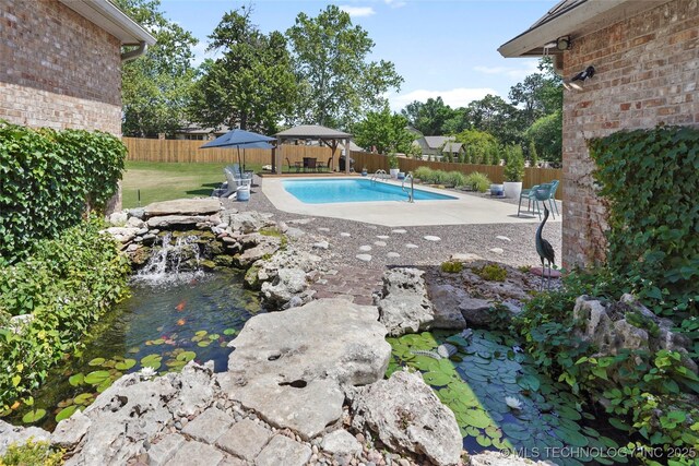 10105 S 72nd E Ave, Tulsa, OK 74133 - view of swimming pool with a fenced backyard, a patio, and a garden pond