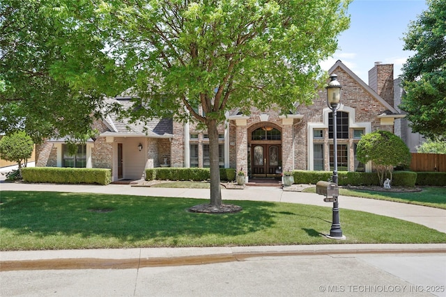 10105 S 72nd E Ave, Tulsa, OK 74133 - obstructed view of property with a front yard, brick siding, and french doors