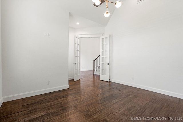 empty room with dark wood-type flooring, baseboards, french doors, and high vaulted ceiling