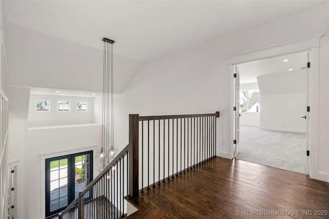 hall featuring an upstairs landing, healthy amount of natural light, wood finished floors, baseboards, and recessed lighting