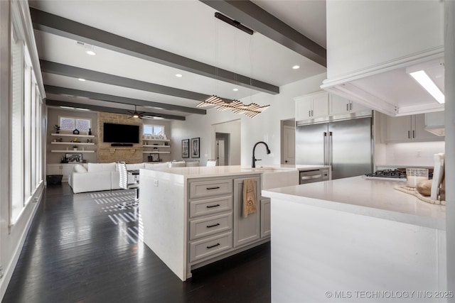 10616 N 81st E Pl, Owasso, OK 74055 - kitchen featuring stainless steel appliances, ceiling fan, light countertops, beam ceiling, and a sink