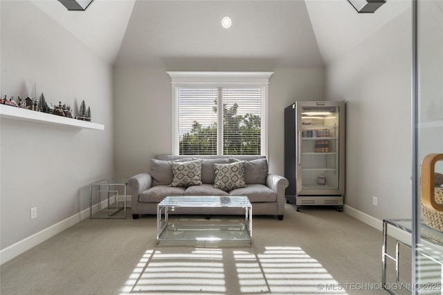 10616 N 81st E Pl, Owasso, OK 74055 - living area featuring lofted ceiling, carpet floors, wine cooler, and baseboards