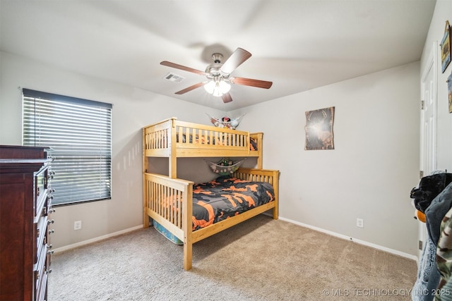 carpeted bedroom featuring baseboards and ceiling fan