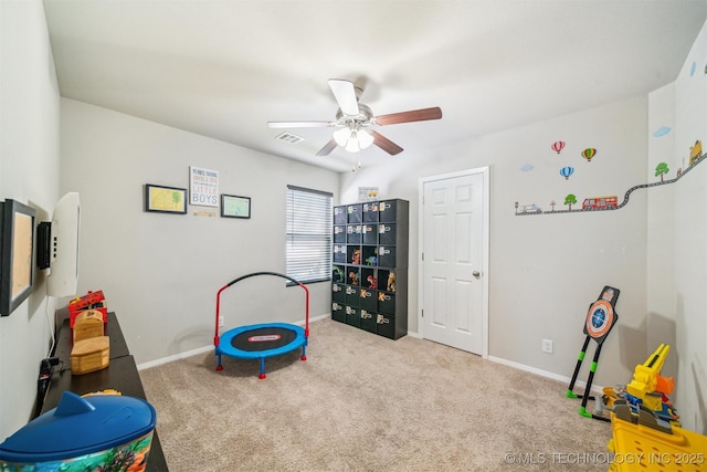 playroom featuring ceiling fan, carpet flooring, and baseboards